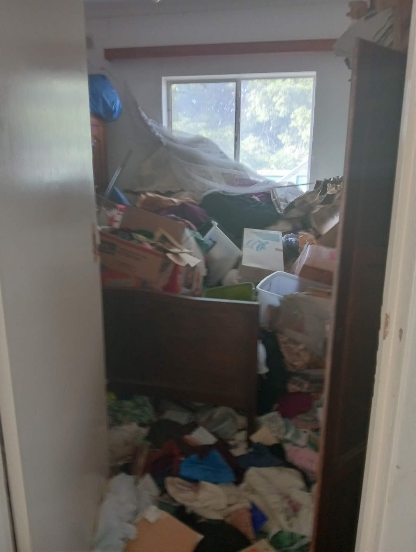 A room filled from floor to ceiling with clutter before clearing